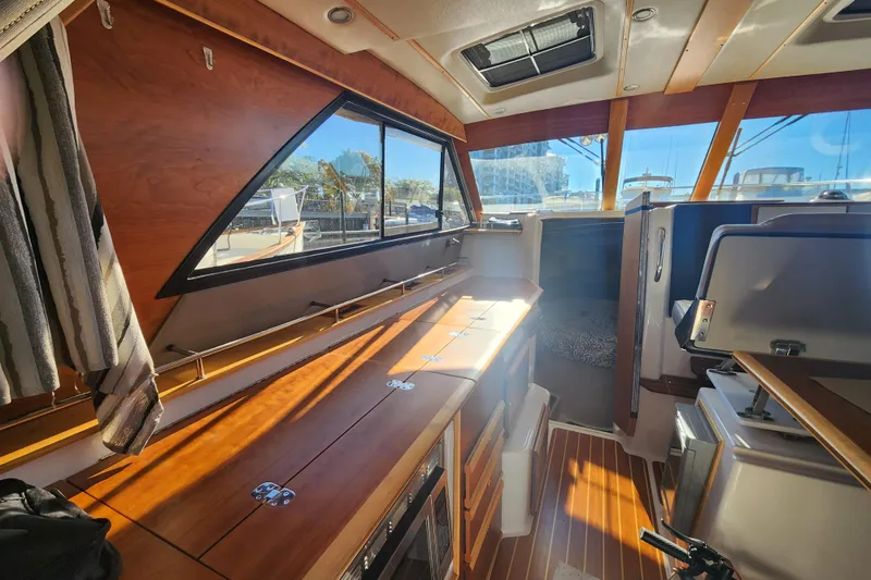  Yacht Photos Pics Interior of 2021 Cutwater C-32 CB boat with wood finishes and ample natural light.