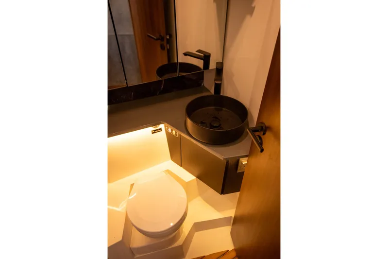  Yacht Photos Pics Modern bathroom in Hanover 447, 2026 model, featuring sleek fixtures and ambient lighting.