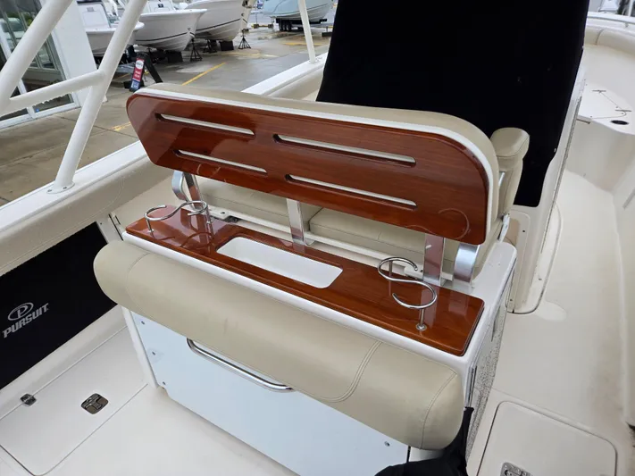  Yacht Photos Pics 2015 Pursuit S280 boat interior with wooden accents and cup holders.