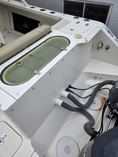  Yacht Photos Pics 2015 Pursuit S280 boat deck with livewell and engine hoses.