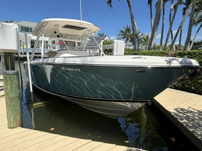  Yacht Photos Pics 2015 Pursuit S280 boat docked near palm trees under clear blue sky.