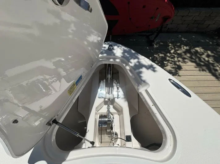  Yacht Photos Pics 2015 Pursuit S280 boat anchor compartment with open hatch, showcasing chain and winch system.
