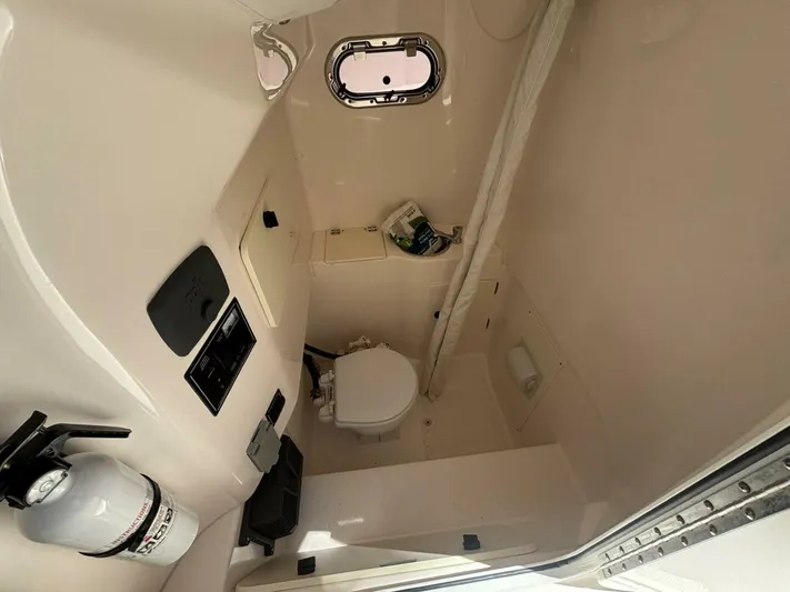  Yacht Photos Pics 2015 Pursuit S280 boat interior with compact bathroom and safety equipment.