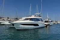 Prestige 420 yacht, 2020 model, docked in a marina with clear blue skies.
