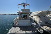 Prestige 420 yacht, 2020 model, docked at marina under clear blue sky.