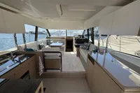 Luxurious interior of a 2020 Prestige 420 yacht with modern furnishings and panoramic windows.
