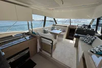 Luxurious interior of 2020 Prestige 420 yacht with modern kitchen and seating area.