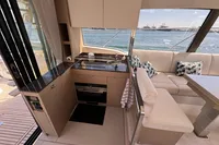 Modern kitchen and seating area on a 2020 Prestige 420 yacht with ocean view.