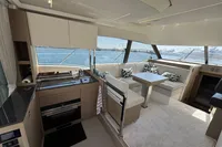 Luxurious interior of a 2020 Prestige 420 yacht with modern kitchen and seating area.