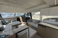 Luxurious interior of a 2020 Prestige 420 yacht with modern seating and panoramic windows.