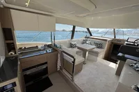 Luxurious interior of 2020 Prestige 420 yacht with modern kitchen and seating area.