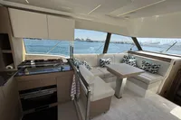 Luxurious interior of a 2020 Prestige 420 yacht with modern seating and ocean view.