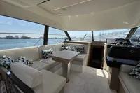 Luxurious interior of 2020 Prestige 420 yacht with elegant seating and scenic ocean view.