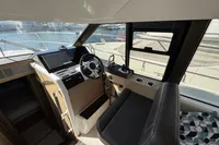 Interior view of 2020 Prestige 420 yacht helm with modern controls and steering wheel.