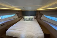 Luxurious cabin interior of 2020 Prestige 420 yacht with elegant bedding and ambient lighting.