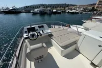 Flybridge of 2020 Prestige 420 yacht docked in a marina, featuring helm and seating area.