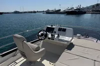 Flybridge of 2020 Prestige 420 yacht with helm station, overlooking marina.