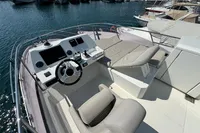 Prestige 420 yacht helm, 2020 model, docked in marina with luxurious seating and controls.