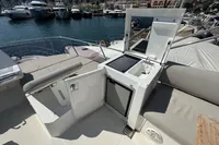 Luxury yacht deck with kitchenette, Prestige 420, 2020 model, docked at marina.