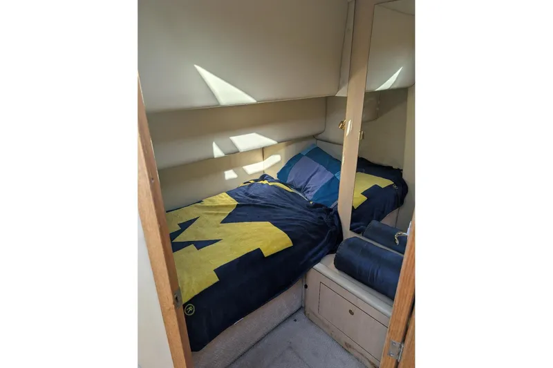 Smitten Yacht Photos Pics Cozy cabin interior of 2000 Sea Ray 420 Aft Cabin with bed and storage.