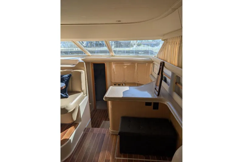 Smitten Yacht Photos Pics Interior of 2000 Sea Ray 420 Aft Cabin yacht with elegant seating and wood flooring.