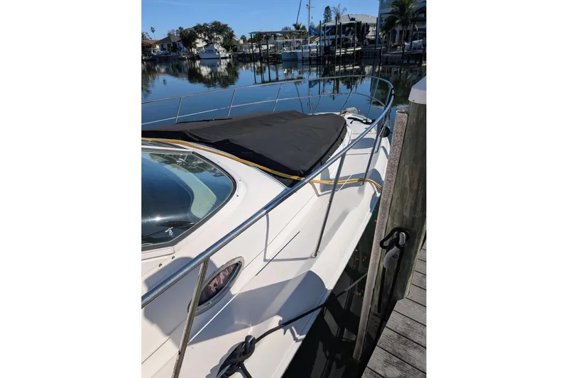 Smitten Yacht Photos Pics 2000 Sea Ray 420 Aft Cabin yacht docked in a serene marina setting.