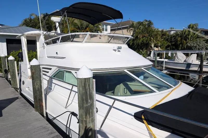 Smitten Yacht Photos Pics 2000 Sea Ray 420 Aft Cabin yacht docked, featuring sleek design and spacious deck.