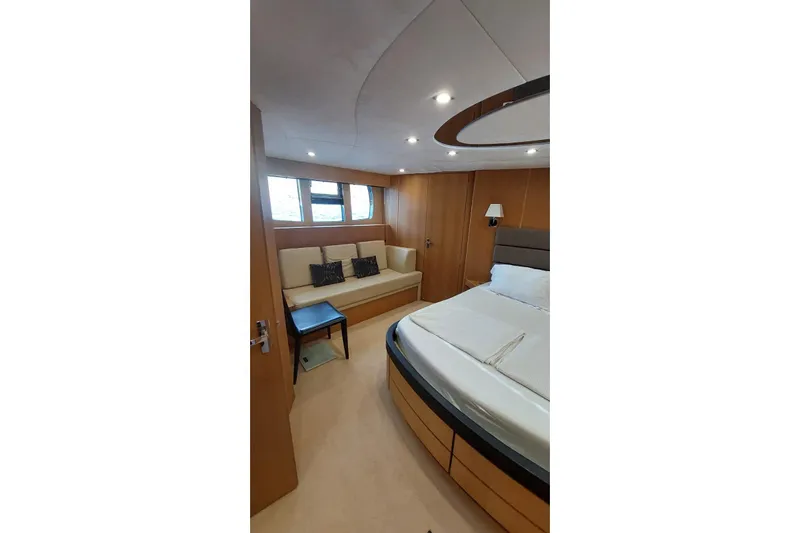  Yacht Photos Pics Luxurious cabin interior of 2010 Fairline Squadron 78 yacht with bed and seating area.