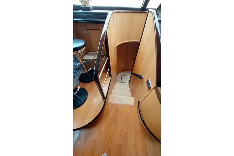  Yacht Photos Pics Interior staircase of 2010 Fairline Squadron 78 yacht, featuring wooden steps and modern design.