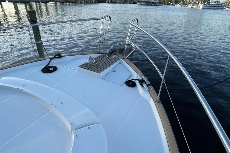 Miss Adventure Yacht Photos Pics 2013 Beneteau Swift Trawler 44 bow view with railing and water backdrop.