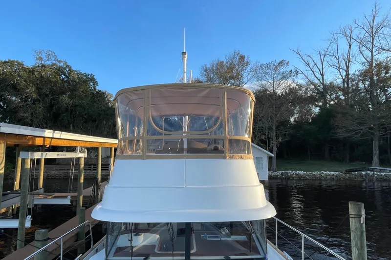 Miss Adventure Yacht Photos Pics 2013 Beneteau Swift Trawler 44 docked by a serene riverside setting.