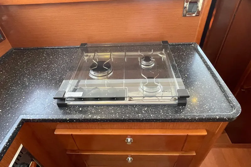 Miss Adventure Yacht Photos Pics 2013 Beneteau Swift Trawler 44 kitchen with a two-burner stove and sleek countertop.