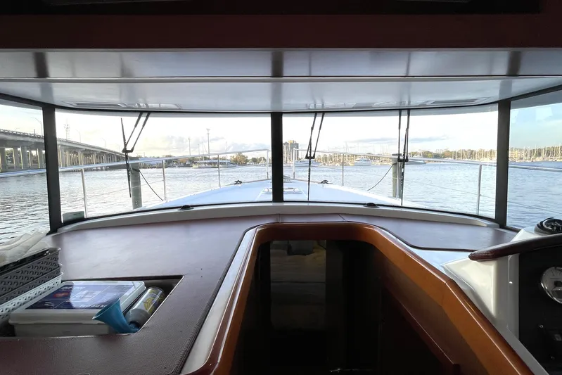 Miss Adventure Yacht Photos Pics Interior view from a 2013 Beneteau Swift Trawler 44, overlooking a serene waterfront.