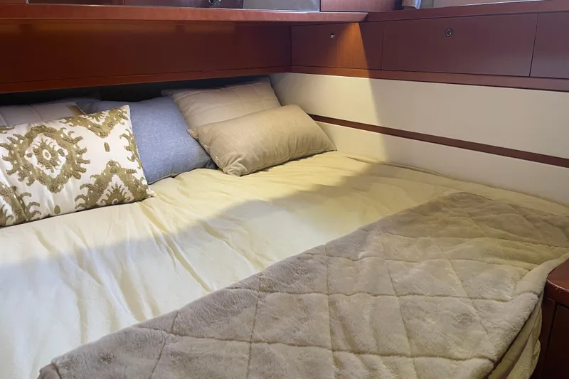 Miss Adventure Yacht Photos Pics Cozy cabin bed in 2013 Beneteau Swift Trawler 44 with decorative pillows.