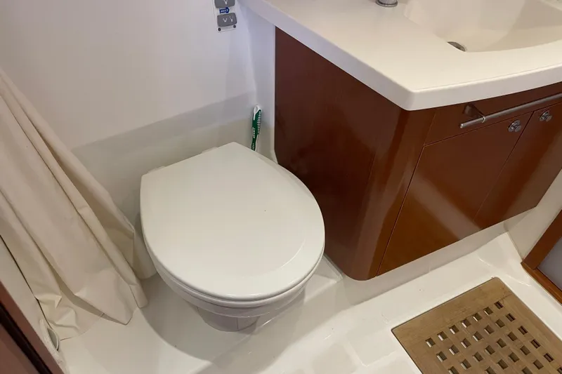 Miss Adventure Yacht Photos Pics Bathroom interior of 2013 Beneteau Swift Trawler 44 with toilet and sink.
