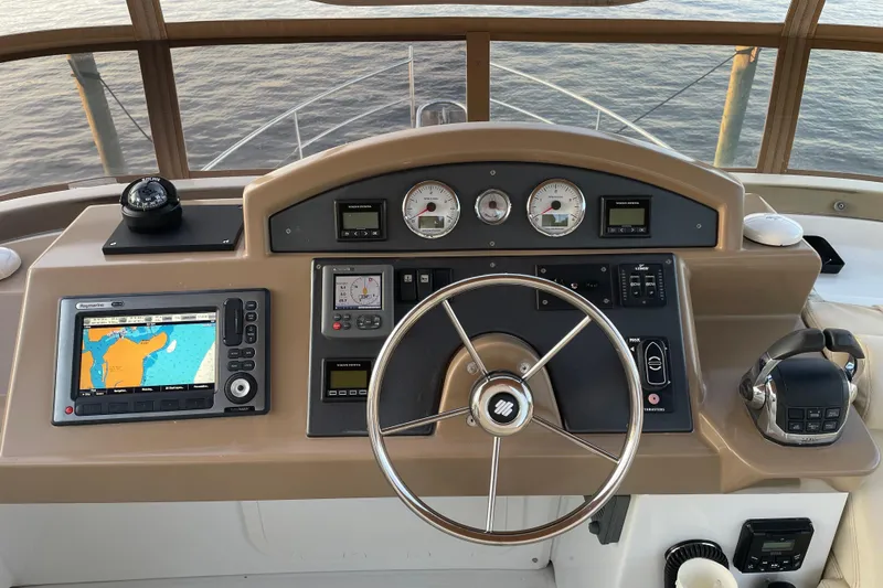 Miss Adventure Yacht Photos Pics Helm of 2013 Beneteau Swift Trawler 44 with navigation equipment and steering wheel.
