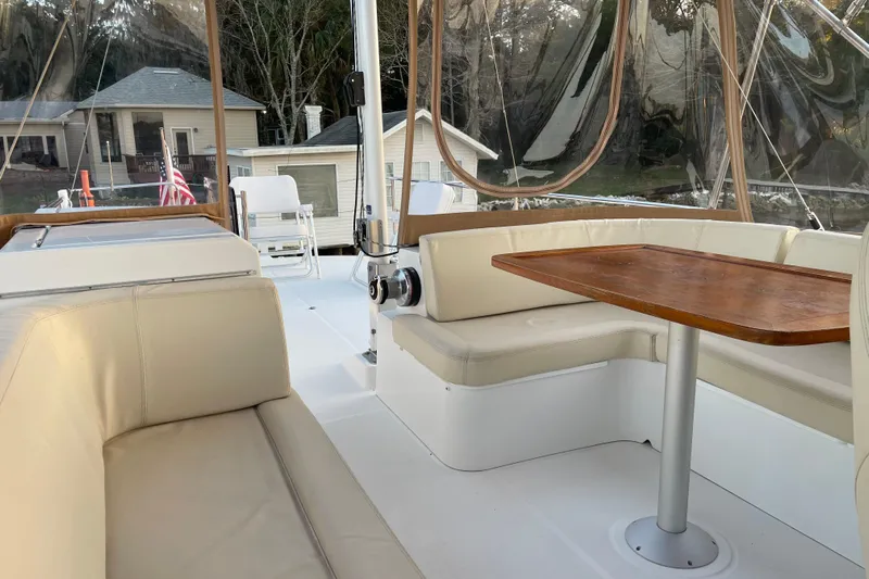 Miss Adventure Yacht Photos Pics 2013 Beneteau Swift Trawler 44 interior with beige seating and wooden table.