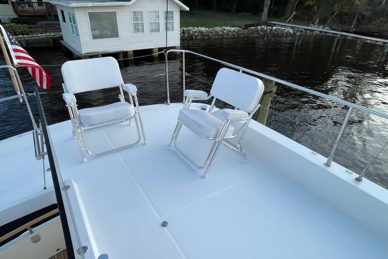Miss Adventure Yacht Photos Pics Deck of 2013 Beneteau Swift Trawler 44 with chairs and water view.
