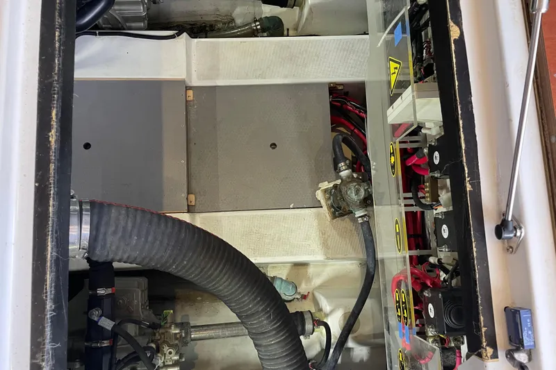 Miss Adventure Yacht Photos Pics Engine compartment of a 2013 Beneteau Swift Trawler 44, showcasing mechanical components and wiring.