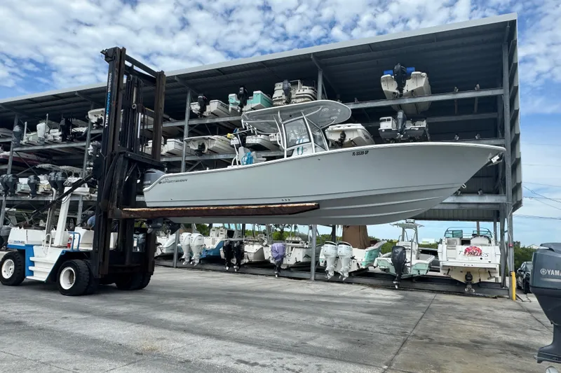  Yacht Photos Pics 2020 Sportsman Open 282TE Center Console boat lifted by forklift in marina storage.