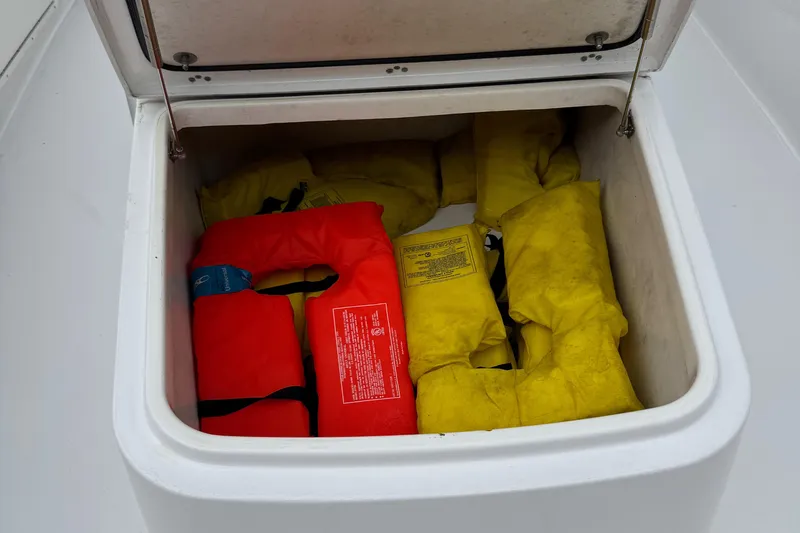  Yacht Photos Pics Storage compartment with life jackets on a 2020 Sportsman Open 282TE Center Console boat.