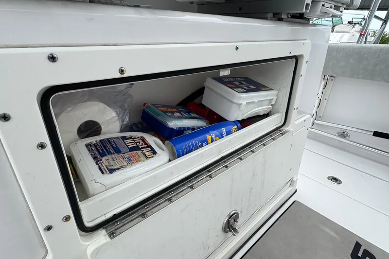  Yacht Photos Pics Storage compartment on a 2020 Sportsman Open 282TE Center Console boat with supplies.
