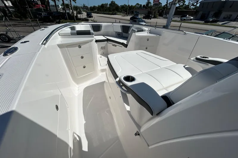  Yacht Photos Pics 2026 Robalo R360 Center Console boat interior with white seating and storage compartments.