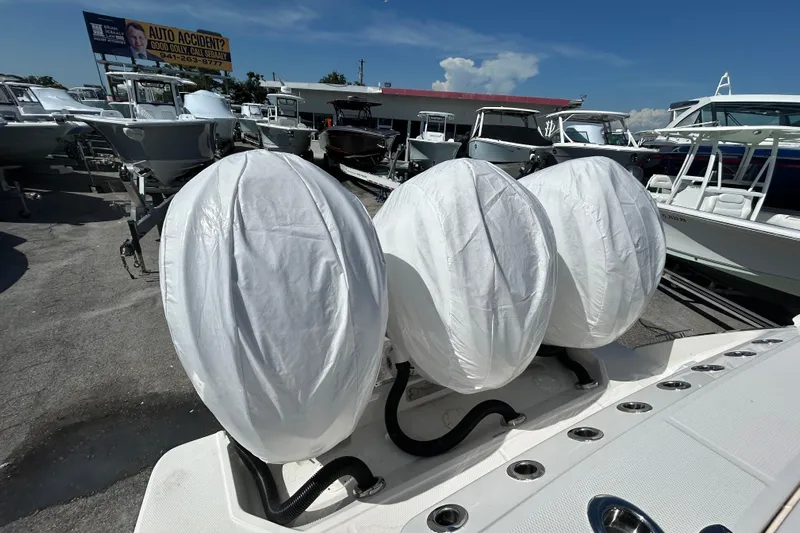 Yacht Photos Pics 2026 Robalo R360 Center Console with covered engines at a boat dealership.