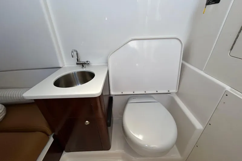  Yacht Photos Pics 2026 Robalo R360 Center Console boat bathroom with sink and toilet.