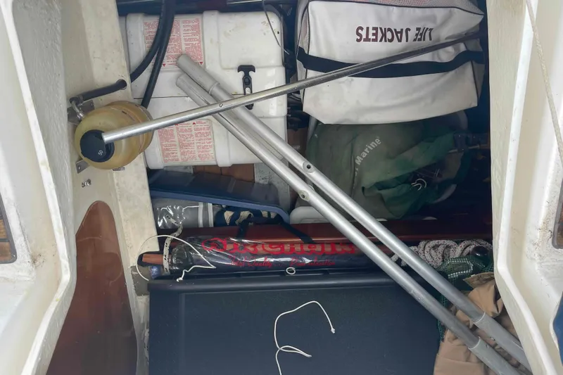 Tiramisu Yacht Photos Pics Storage compartment of a 2004 Beneteau Oceanis 473 sailboat with life jackets and equipment.
