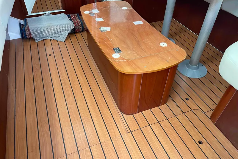 Tiramisu Yacht Photos Pics Interior of 2004 Beneteau Oceanis 473 sailboat with wooden flooring and table.