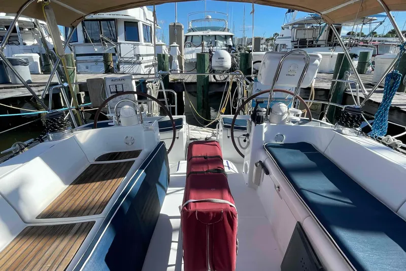 Tiramisu Yacht Photos Pics Cockpit of 2004 Beneteau Oceanis 473 sailboat docked at marina, featuring dual steering wheels.