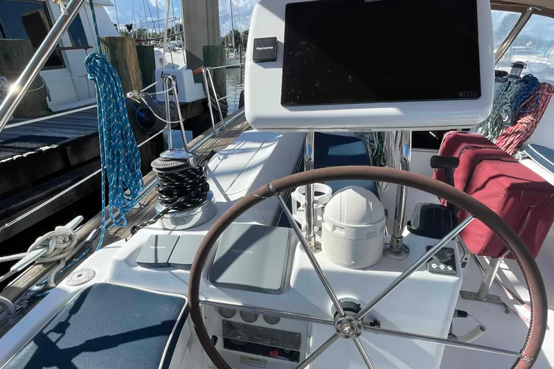 Tiramisu Yacht Photos Pics Cockpit of 2004 Beneteau Oceanis 473 sailboat with steering wheel and navigation equipment.