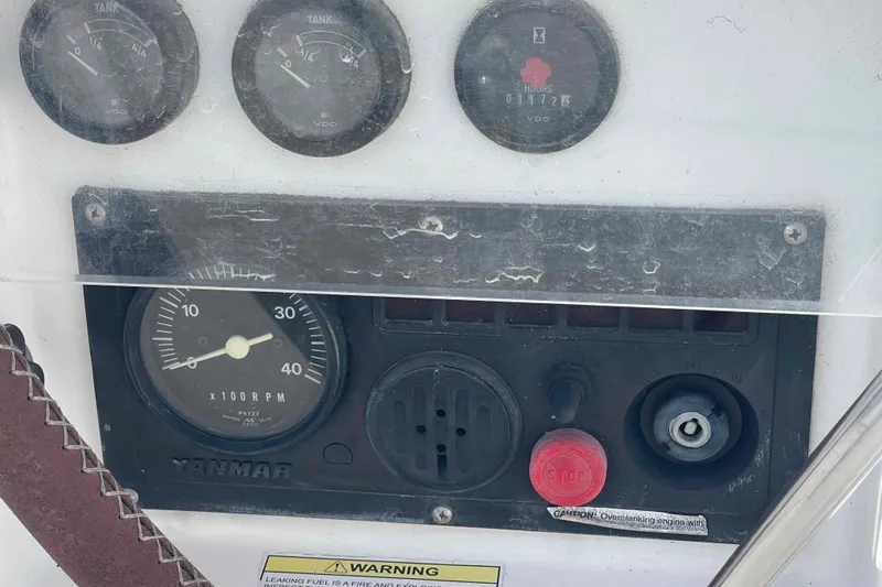 Tiramisu Yacht Photos Pics Control panel of a 2004 Beneteau Oceanis 473 sailboat with gauges and warning labels.